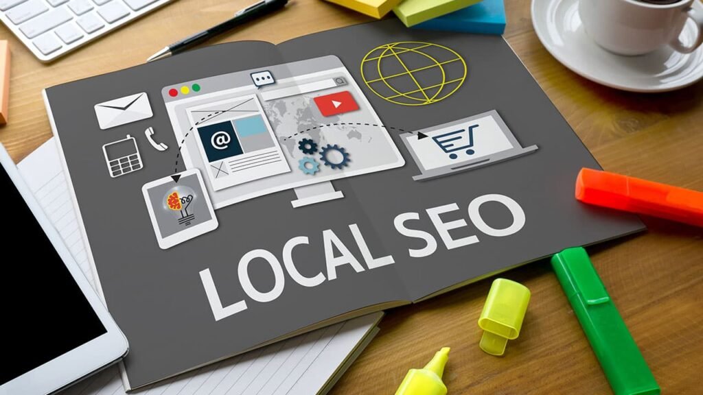 Visual representation of Local SEO with icons like a globe, shopping cart, email, and gears on an open notebook, emphasizing strategies for optimizing a business's online presence for local searches.